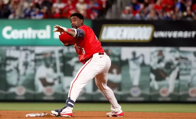 St. Louis Cardinals' Jordan Walker gestures toward the dugout after hitting a double during the fifth inning of a baseball game against the Los Angeles Dodgers Friday, May 1, 2026, in St. Louis. (AP Photo/Scott Kane)