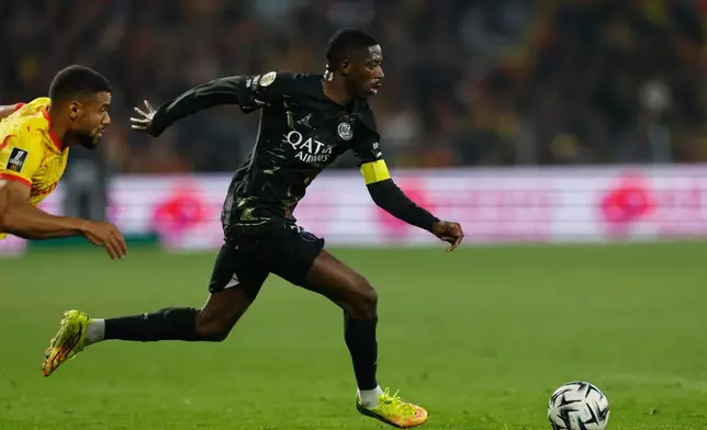 PSG's Ousmane Dembele runs with the ball during the French League One soccer match between Lens and Paris Saint Germain, in Lens, northern France, Wednesday, May 13, 2026. (AP Photo/Jean-Francois Badias)