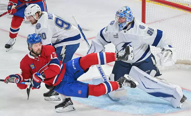 Montreal Canadiens' Josh Anderson (17) collides with Tampa Bay Lightning goaltender Andrei Vasilevskiy (88) as Lightning's J.J. Moser (90) defends during Game 6 in the first round of an NHL hockey Stanley Cup playoff series in Montreal, Friday, May 1, 2026. (Graham Hughes/The Canadian Press via AP)