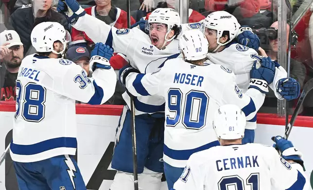 Tampa Bay Lightning's Gage Goncalves, second from left, celebrates with teammates after scoring against the Montreal Canadiens during overtime of Game 6 in the first round of an NHL hockey Stanley Cup playoff series in Montreal, Friday, May 1, 2026. (Graham Hughes/The Canadian Press via AP)