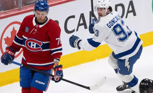 Tampa Bay Lightning's Gage Goncalves (93) celebrates after his winning goal as Montreal Canadiens' Zachary Bolduc (76) reacts during overtime of Game 6 in the first round of an NHL hockey Stanley Cup playoff series in Montreal, Friday, May 1, 2026. (Christinne Muschi/The Canadian Press via AP)