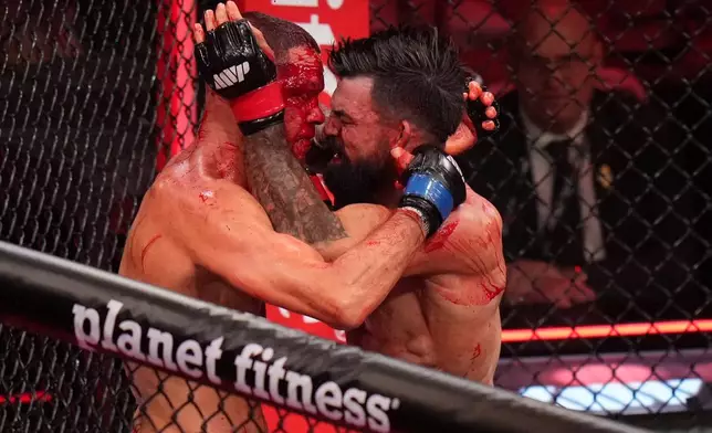 Mike Perry, of the United States, right, fights Nate Diaz, of the United States, during their welterweight mixed martial arts fight Saturday, May 16, 2026, in Inglewood, Calif. (AP Photo/Jae C. Hong )