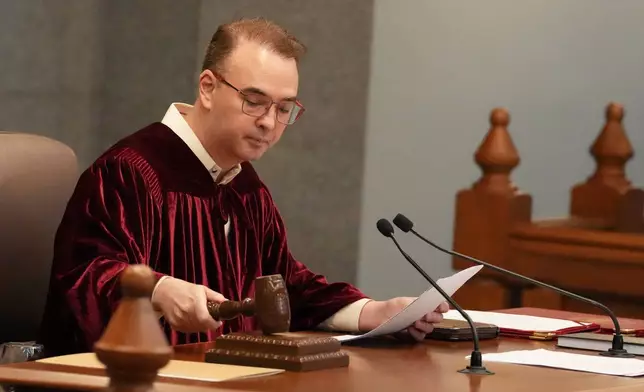 Philippine Senate President Alan Peter Cayetano bangs the gavel as they convene as an impeachment court for the trial of Vice President Sara Duterte at the Philippine senate, Monday, May 18, 2026, in Pasay, Philippines. (AP Photo/Aaron Favila)