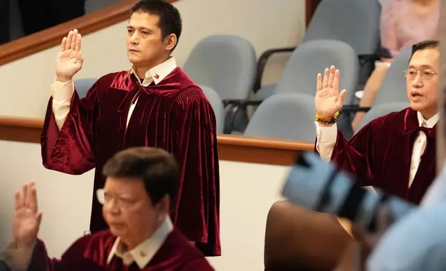 Philippine senator Robin Padilla, left, and Christopher "Bong" Go takes oath as they convene as an impeachment court for the trial of Vice President Sara Duterte at the Philippine senate, Monday, May 18, 2026, in Pasay, Philippines. (AP Photo/Aaron Favila)