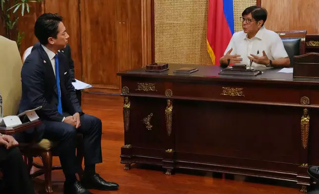 Philippine President Ferdinand Marcos Jr., right, talks with Japan's Defense Minister Shinjiro Koizumi at the Malacanang presidential palace in Manila, Philippines on Tuesday, May 5, 2026. (AP Photo/Aaron Favila, POOL)