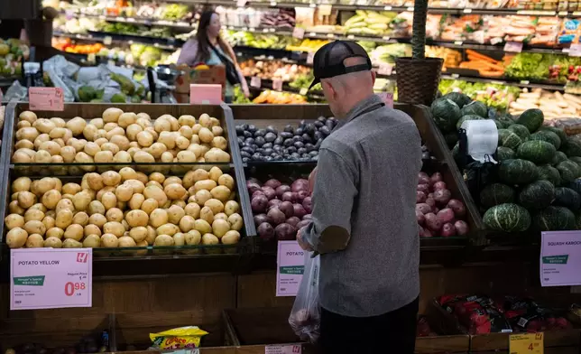 Customers shop in the produce section of a grocery store on Monday, May 11, 2026, in Portland, Ore. (AP Photo/Jenny Kane)
