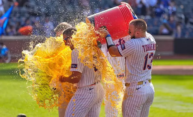 New York Mets' players dump a cooler on Tyrone Taylor, left, after a baseball game against the New York Yankees, Sunday, May 17, 2026, in New York. (AP Photo/Seth Wenig)