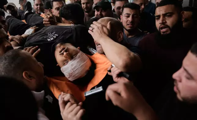 The body of Nayef Samaro, 26, who was killed in clashes with Israeli forces, is brought to Rafidia Hospital in the West Bank city of Nablus, Sunday, May 3, 2026. (AP Photo/Majdi Mohammed)