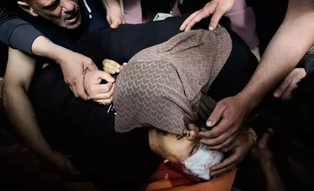 Mother of Nayef Samaro, 26, who was killed in clashes with Israeli forces, mourns over his body at Rafidia Hospital in the West Bank city of Nablus, Sunday, May 3, 2026. (AP Photo/Majdi Mohammed)