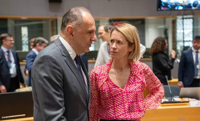 Greece's Foreign Minister Giorgos Gerapetritis, left, speaks with European Union foreign policy chief Kaja Kallas during a round table meeting of EU foreign ministers at the European Council building in Brussels, Monday, May 11, 2026. (AP Photo/Marius Burgelman)
