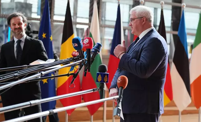 Ukraine's Foreign Minister Andrii Sybiha, right, speaks with the media as he arrives for a meeting of EU foreign ministers at the European Council building in Brussels, Monday, May 11, 2026. (AP Photo/Virginia Mayo)