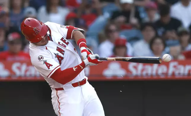 Los Angeles Angels' Mike Trou hits an RBI single that scored Angels' Sebastian Rivero during the third inning of a baseball game against the Texas Rangers, Sunday, May 24, 2026, in Anaheim, Calif. (AP Photo/Caroline Brehman)
