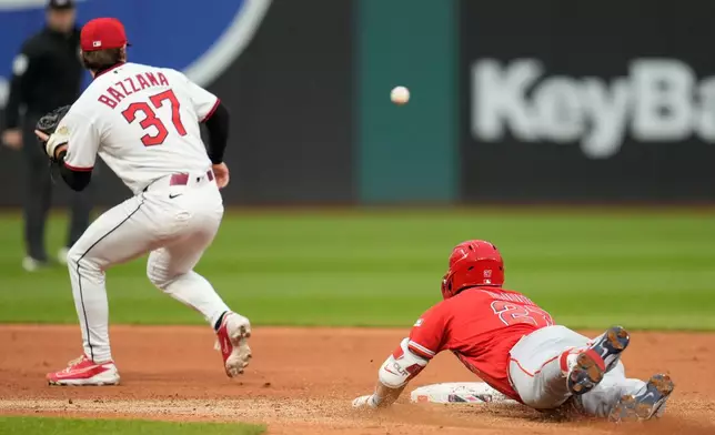 Los Angeles Angels' Mike Trout, right, slides into second base with a double as Cleveland Guardians second baseman Travis Bazzana (37) takes the throw in the fifth inning of a baseball game in Cleveland, Tuesday, May 12, 2026. (AP Photo/Sue Ogrocki)