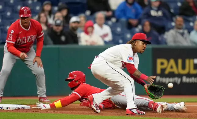Los Angeles Angels' Oswald Peraza, center, slides safely into third base with a triple as Cleveland Guardians third baseman José Ramírez, right, takes the throw in the sixth inning of a baseball game in Cleveland, Tuesday, May 12, 2026. (AP Photo/Sue Ogrocki)