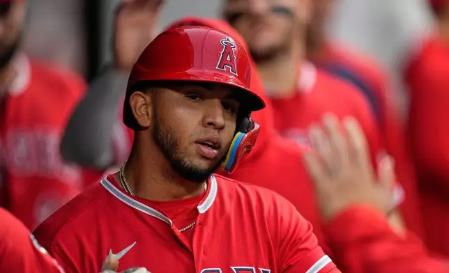 Los Angeles Angels' Oswald Peraza is congratulated after scoring in the sixth inning of a baseball game against the Cleveland Guardians in Cleveland, Tuesday, May 12, 2026. (AP Photo/Sue Ogrocki)