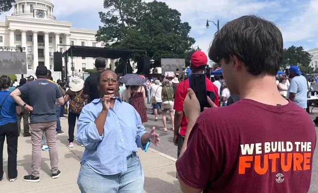 Kobe Chernushin, right, records Khayla Doby for the Georgia Youth Justice Coalition during a voting rights rally in Montgomery, Ala., Saturday, May 16, 2026. (AP Photo/Bill Barrow)