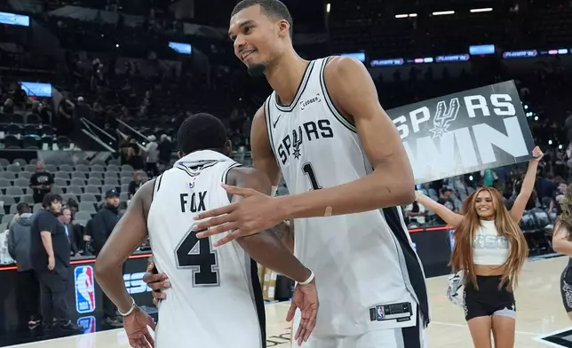 San Antonio Spurs forward/center Victor Wembanyama (1) greets guard De'aaron Fox (4) after Game 5 of a first-round NBA playoffs basketball series against the Portland Trail Blazers in San Antonio, Tuesday, April 28, 2026. (AP Photo/Eric Gay)