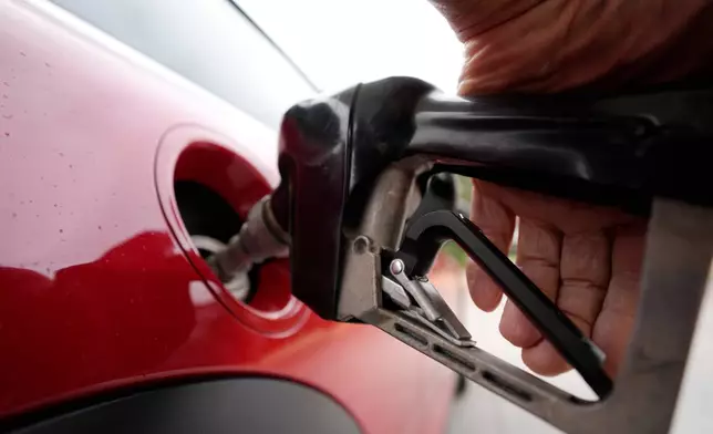 FILE - A motorist pumps fuel at a Shell station Wednesday, July 5, 2023, in Englewood, Colo. (AP Photo/David Zalubowski, File)