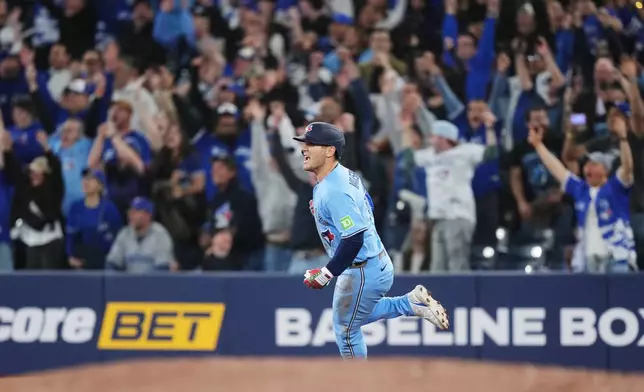 Toronto Blue Jays' Daulton Varsho (5) rounds the bases after hitting a walk-off grand slam against the Tampa Bay Rays during 10th inning MLB baseball action in Toronto on Wednesday, May 13, 2026. (Nathan Denette/The Canadian Press via AP)