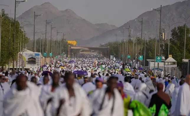 Muslim pilgrims walk towards the rocky hill known as the Mountain of Mercy, on the Plain of Arafat, during the annual Hajj pilgrimage near the holy city of Mecca, Saudi Arabia, Tuesday, May 26, 2026. (AP Photo/Altaf Qadri)