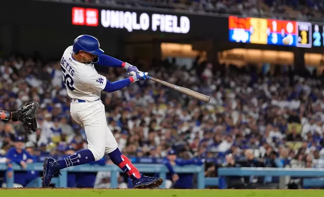 Los Angeles Dodgers' Mookie Betts hits a solo home run during the third inning of a baseball game against the San Francisco Giants, Wednesday, May 13, 2026, in Los Angeles. (AP Photo/Mark J. Terrill)