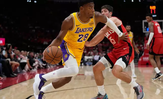 Los Angeles Lakers forward Rui Hachimura (28) controls the ball against Houston Rockets guard Reed Sheppard (15) during the first half of Game 6 of a first-round NBA playoffs basketball series in Houston, Friday, May 1, 2026. (AP Photo/Ashley Landis)