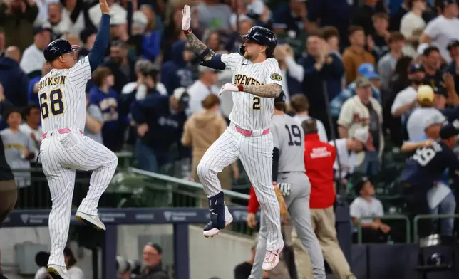 Milwaukee Brewers' Brice Turang (2) gets a high-five after his walk off home run in the ninth inning against the New York Yankees, Sunday, May 10, 2026, in Milwaukee. (AP Photo/Jeffrey Phelps)