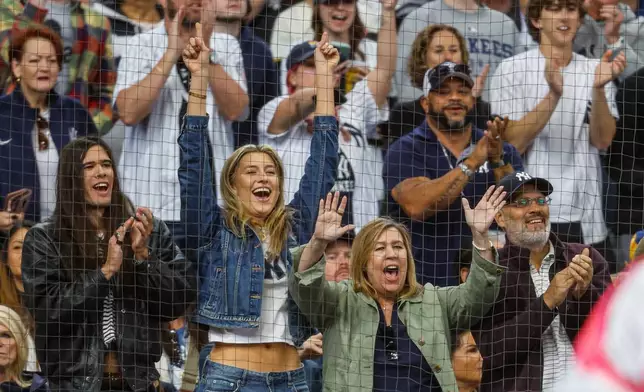 New York Yankees Spencer Jones' girlfriend, center left and his parents, bottom right, watch his first major league hit during the second inning of a baseball game against the Milwaukee Brewers, Sunday, May 10, 2026, in Milwaukee. (AP Photo/Jeffrey Phelps)