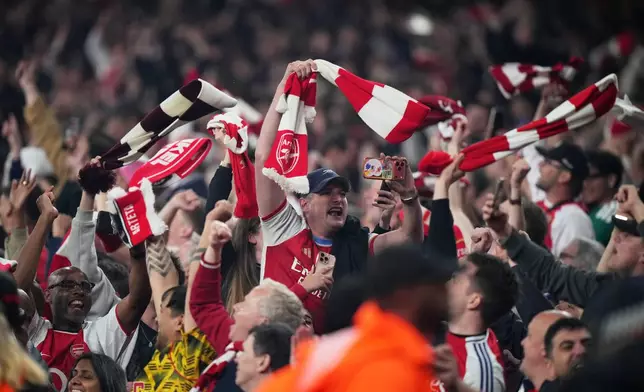 Arsenal supporters celebrate at the the end of a Champions League semifinal, second leg, soccer match between Arsenal FC and Atletico Madrid in London, Tuesday, May 5, 2026. (AP Photo/Alastair Grant)