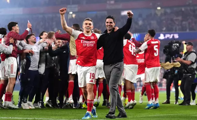 Arsenal's Leandro Trossard, left, and manager Mikel Arteta celebrate at the the end of a Champions League semifinal, second leg, soccer match between Arsenal FC and Atletico Madrid in London, Tuesday, May 5, 2026. (John Walton/PA via AP)