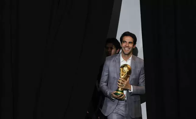 Former Brazilian soccer star Kaká, holding a World Cup trophy, enters for a panel on the 2026 FIFA World Cup soccer tournament halftime show during the Global Citizen NOW summit, Thursday, May 14, 2026, in New York. (AP Photo/Heather Khalifa)