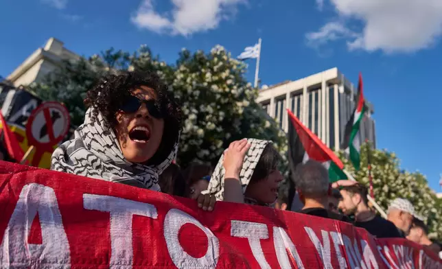 Protesters chant pro-Palestinian slogans outside Greece's Foreign Ministry after Israel's navy intercepted an activists flotilla in waters off of Cyprus, in Athens on Monday, May 18, 2026. (AP Photo/Petros Giannakouris)