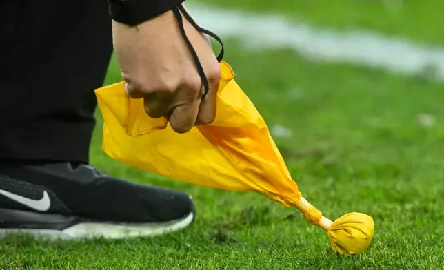 FILE - A referee picks up a penalty flag during an NFL football game between the Cleveland Browns and the Kansas City Chiefs, Sunday, Dec. 15, 2024, in Cleveland. (AP Photo/David Richard, File)