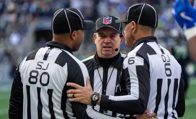 FILE - Field judge Alonzo Ramsey, left, back judge Greg Wilson and down judge Jerod Phillips confer during an NFL football game against the Seattle Seahawks, Sunday, Nov. 3, 2024, in Seattle. (AP Photo/Stephen Brashear, File)