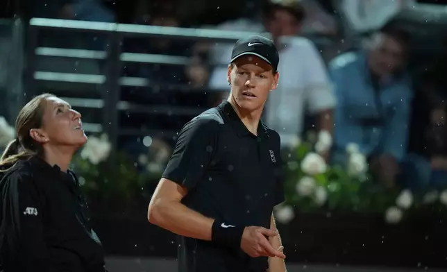 Italy's Jannik Sinner ask to the referee to stop the match because of the rain during the semifinal match against Daniil Medvedev of Russia at the Italian Open tennis tournament in Rome, Friday, May 15, 2026. (AP Photo/Andrew Medichini))