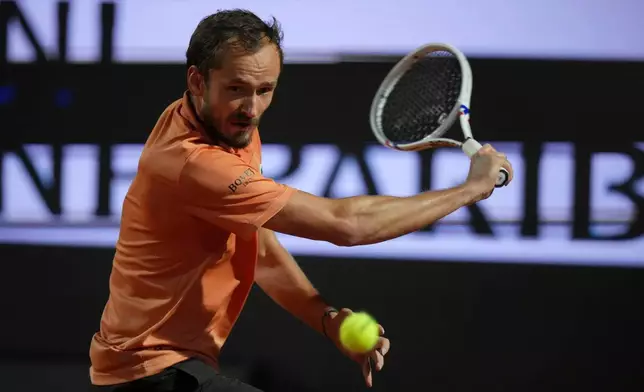 Daniil Medvedev of Russia returns a ball to Italy's Jannik Sinner during their semifinal match at the Italian Open tennis tournament in Rome, Friday, May 15, 2026. (AP Photo/Andrew Medichini)
