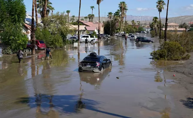 FILE - Cars are seen stuck in the mud following Tropical Storm Hilary on a street Aug. 21, 2023, in Cathedral City, Calif. (AP Photo/Mark J. Terrill, File)