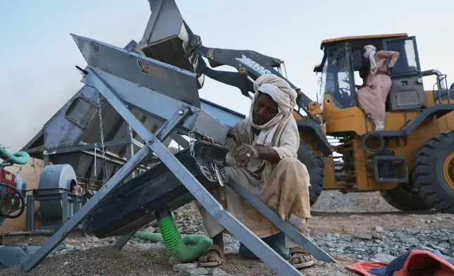 An artisanal miner operates an ore-processing machine used to separate gold-bearing material at a mining site in Dalago Mahas, Sudan's Northern State, Thursday, May 7, 2026.(AP Photo/Mohnd Blal)