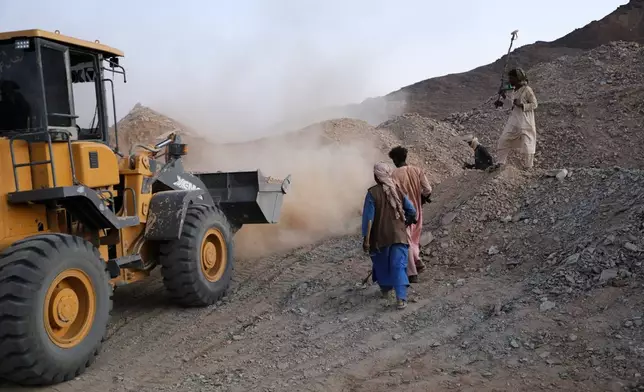 A front-loader loads dirt and crushed rock into a processing machine used to separate gold-bearing material at an artisanal mining site in Dalago Mahas, Sudan's Northern State, Thursday, May 7, 2026. (AP Photo/Mohaned Bilal)