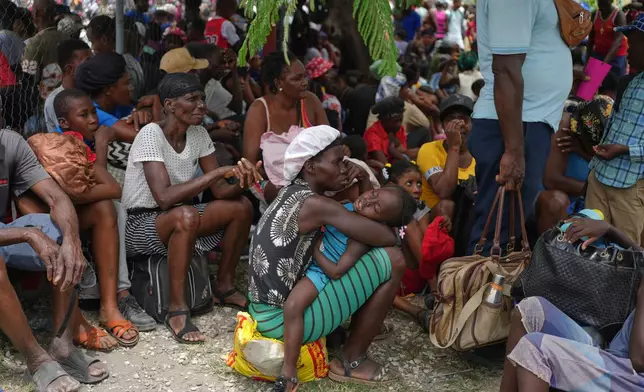 People displaced from their homes due to clashes between armed gangs take refuge at a police station in Port-au-Prince, Haiti, Monday, May 11, 2026. (AP Photo/Odelyn Joseph)