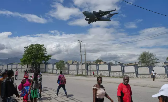 A U.S. military cargo plane prepares to land at the Toussaint Louverture airport as some people flee gang violence in Port-au-Prince, Haiti, Monday, May 11, 2026. (AP Photo/Odelyn Joseph)