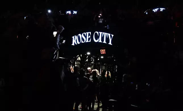 Portland Fire players huddle in the tunnel before player introductions before a WNBA basketball game against the Chicago Sky, on Saturday, May 9, 2026, in Portland, Ore. (AP Photo/Jenny Kane, File)