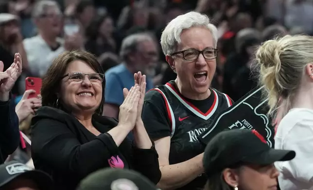 Oregon Gov. Tina Kotek, right, reacts after a play during the second half of a WNBA basketball game between the Portland Fire and the Chicago Sky, Saturday, May 9, 2026, in Portland, Ore. (AP Photo/Jenny Kane)