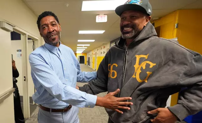 Former NBA basketball player Jimmy King, left, talks with Jalen Rose, right, at the Jalen Rose Leadership Academy, Monday, April 20, 2026, in Detroit. (AP Photo/Paul Sancya)