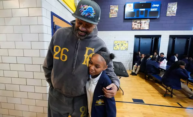 Former NBA basketball player Jalen Rose hugs a student at the Jalen Rose Leadership Academy, Monday, April 20, 2026, in Detroit. (AP Photo/Paul Sancya)