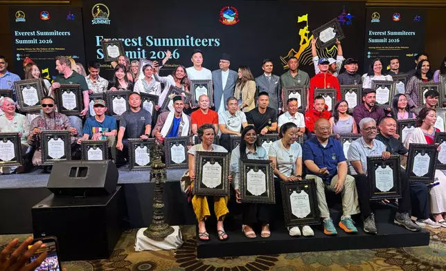 Everest climbers pose for a group photo during the 'Everest Summiteers Summit' in Kathmandu, Nepal, Wednesday, May 27, 2026. (AP Photo/Upendra Man Singh)