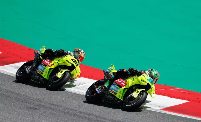 Italian rider Franco Morbidelli of the Pertamina Enduro VR46 Racing Team steers his motorcycle followed by Italian rider Fabio Di Giannantonio of the Pertamina Enduro VR46 Racing Team during the MotoGP race of the Grand Prix of Catalunya in Montmelo, near Barcelona, Spain, Sunday, May 17, 2026. (AP Photo/Joan Monfort)