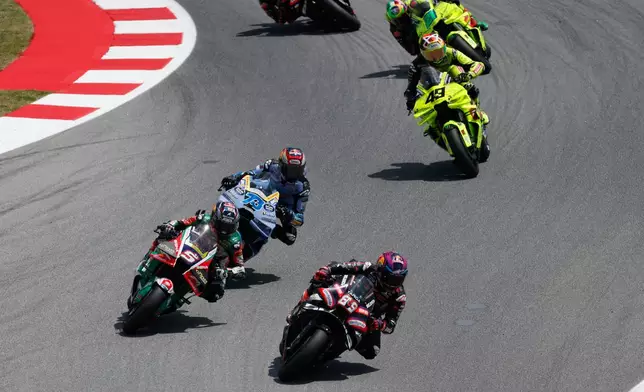 Spain's rider Jorge Martin of the Aprilia Racing steers his motorcycle followed by France's rider Johann Zarco of the CASTROL Honda LCR and Spain's rider Alex Marquez of the BK8 Gresini Racing MotoGP during the MotoGP race of the Grand Prix of Catalunya in Montmelo, near Barcelona, Spain, Sunday, May 17, 2026. (AP Photo/Joan Monfort)