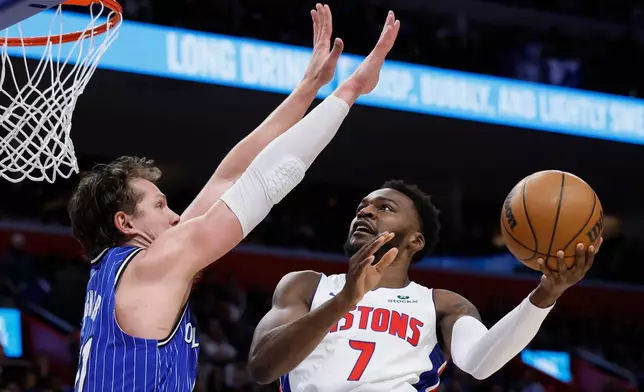 Detroit Pistons forward Paul Reed (7) goes to the basket against Orlando Magic forward Moritz Wagner, left, during the first half in Game 7 of a first-round NBA basketball playoffs series Sunday, May 3, 2026, in Detroit. (AP Photo/Duane Burleson)