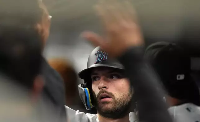 Miami Marlins' Joe Mack celebrates with teammates after grounding out to bring in a run by Jakob Marsee, during the second inning of a baseball game against the Atlanta Braves, Monday, May 18, 2026, in Miami. (AP Photo/Rebecca Blackwell)